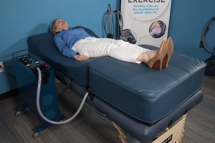 Natural Immune Support with PEMF Woman lays on a PEMF total body contour bed