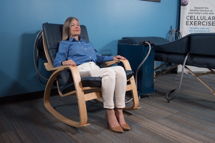 Natural Immune Support with PEMF Woman relaxes in a chair on a PEMF chair paid