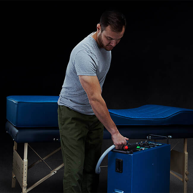 Pulse XLPRO A man adjusting a PEMF machine