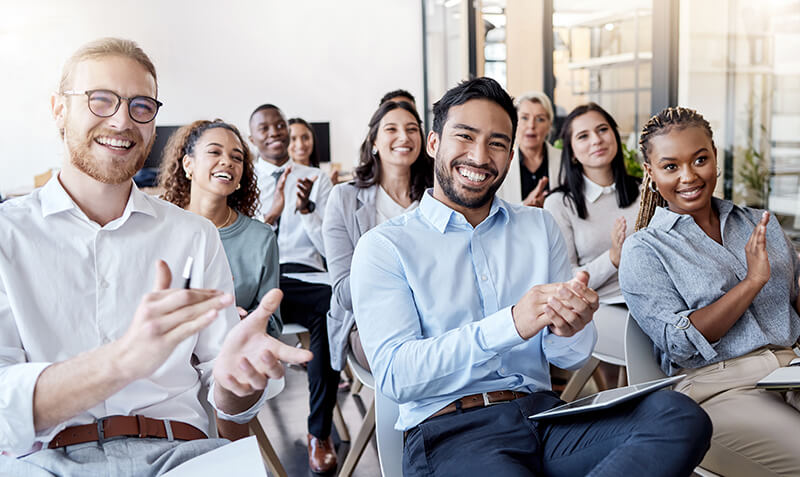 Continuing Your Education: Building Your Animal Expertise A diverse group of students in a classroom clapping enthusiastically.