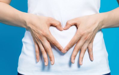 Hands of a lady shaping a heart.